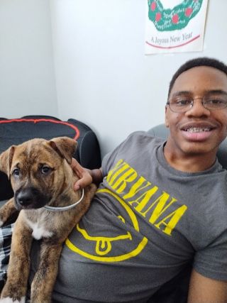 15-year-old African American male on couch with dog.