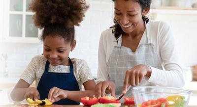 Child and parent preparing a meal together