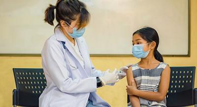 Health provider administering a vaccine to a child